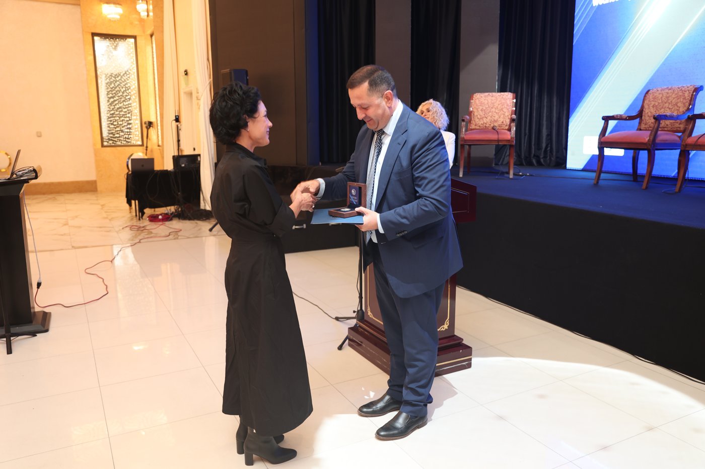 Rector Hovhannes Hovhannisyan presenting Rachel with the Zabel Yesayan Medal
